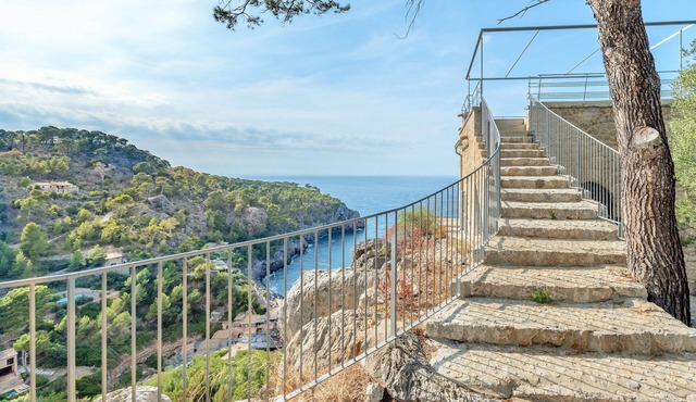 Deia tower overlooking the sea and it famous cove. in Deyá