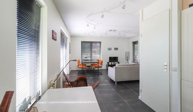 Detached villa with a patio and jetty next to open waters in Makkum